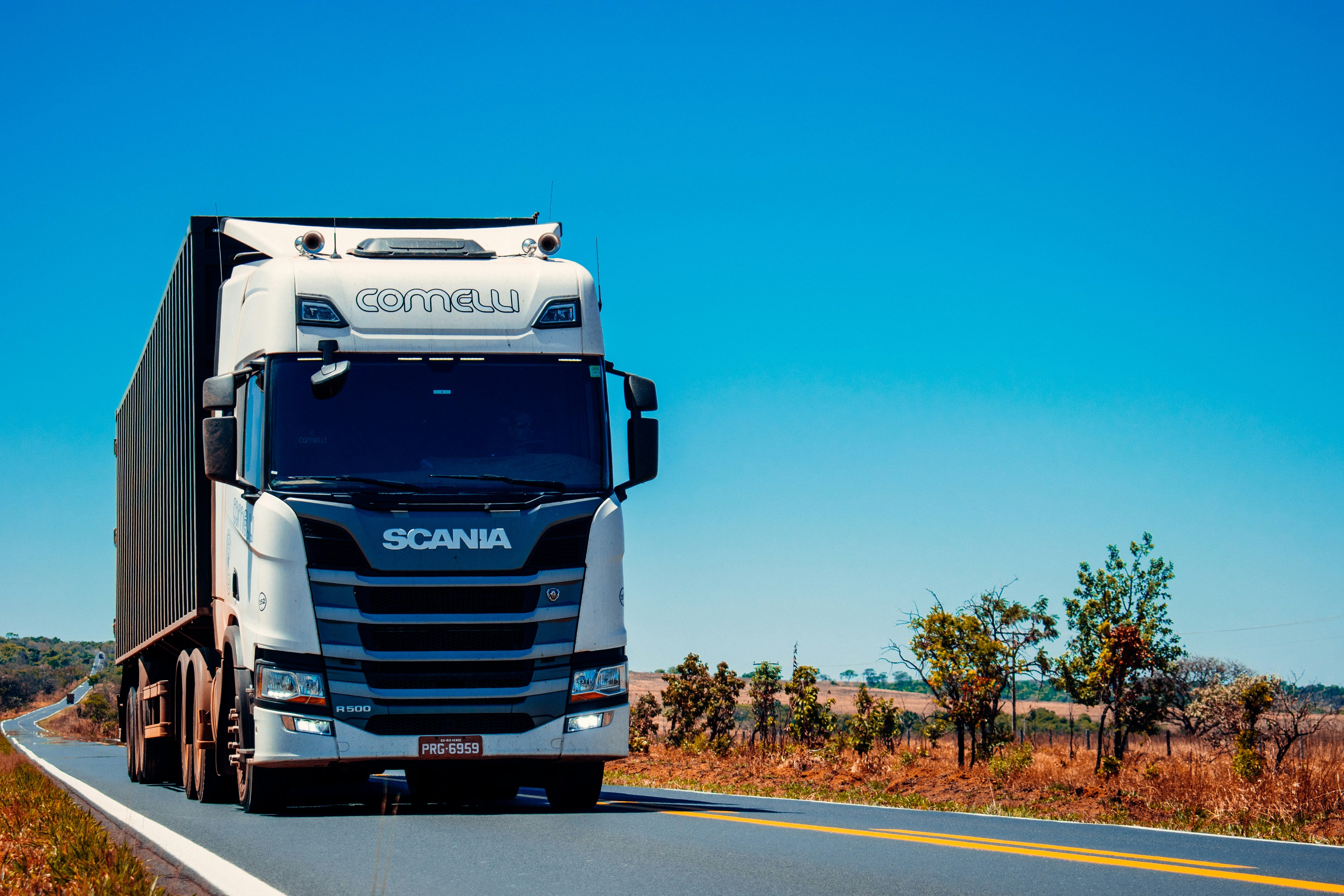 Scania truck on a road with a clear blue sky